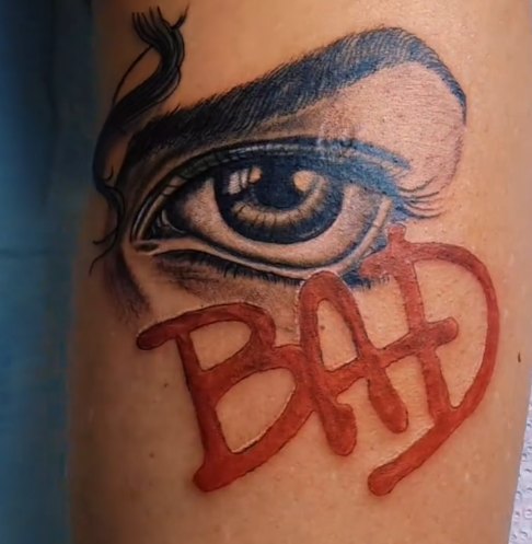 Eye and lettering tattoo by Skin Deep Tattoos
